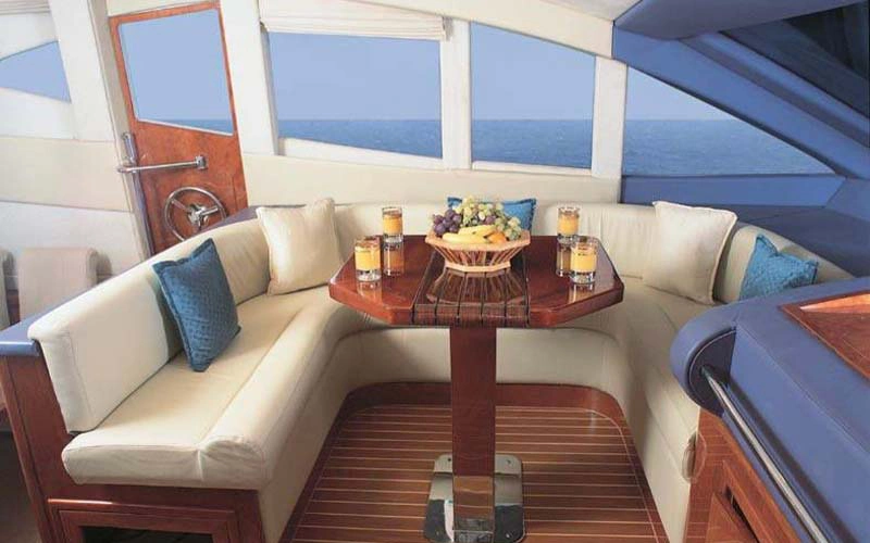 Fine dining area inside Lady of the Sea yacht with a wood-finished table setup