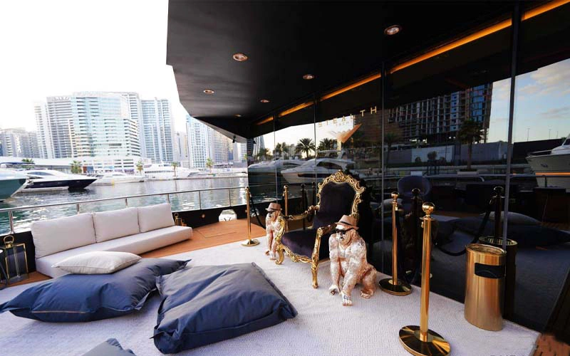 Modern lounge inside Stealth Yacht with black leather seating and LED accent lighting