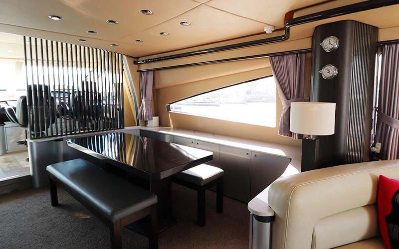 Indoor lounge on SunSeeker Yacht with plush sofa seating and large windows offering sea views