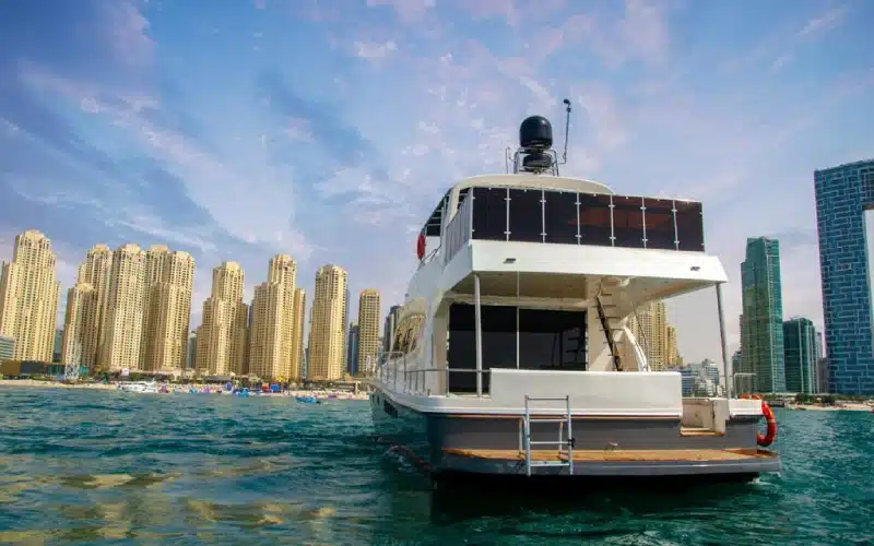 Sunlit aft deck of Sea Fish Yacht showcasing outdoor seating, BBQ grill area, and water sports setup