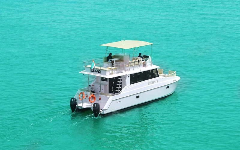 The Bird cruising in Greek waters with sleek profile and guests on foredeck