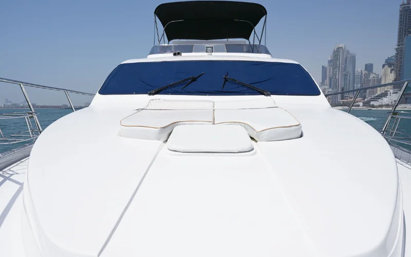 Maze Yacht anchored near a marina, showcasing its modern lines and expansive deck space