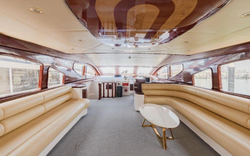 Main salon aboard Ocean Seeker II featuring plush seating, panoramic side windows, and ambient LED ceiling lighting—ideal for relaxing at sea