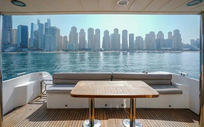 Forward dining area on main deck with a formal table setup, soft ambient lighting, and ocean-facing vistas