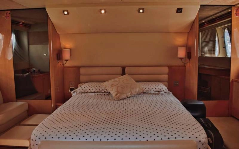 Modern guest bedroom on Speed Rock Yacht featuring a double bed, soft lighting, and panoramic window views
