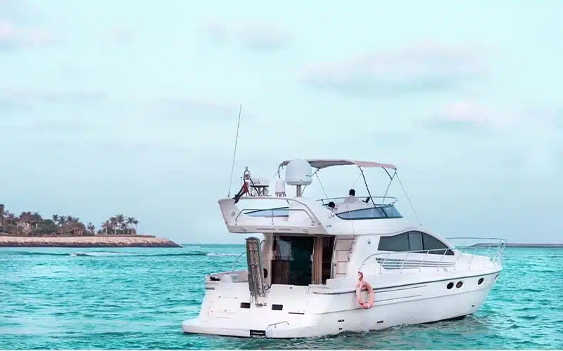 Rear view of Wrong 2 Yacht docked at Dubai Marina, highlighting the swim platform, stainless handrails, and teak aft deck