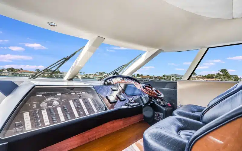 Captain’s helm on Superfly Yacht with sleek dashboard controls, navigation screens, and 360° view from the flybridge helm station