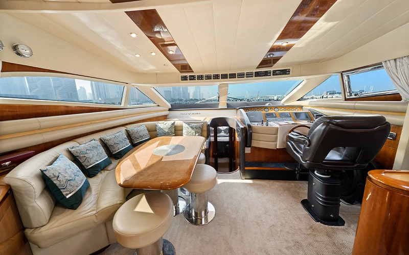 Dining area on Lava Yacht with elegant table setup, cushioned seating, and side window views