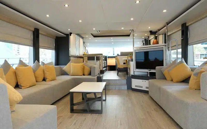 Open-plan interior combining the dining space and salon with panoramic sea views, creating a luxurious and inviting setting