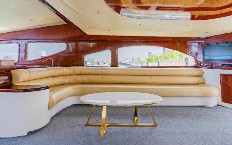 Ocean Seeker 2 Yacht’s lounge area with modern sofas, soft lighting, and panoramic windows creating a cozy and elegant atmosphere