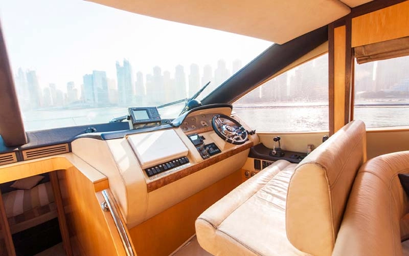 Captain’s helm station on Major Yacht featuring leather seat, navigation controls, and wide front-facing windows