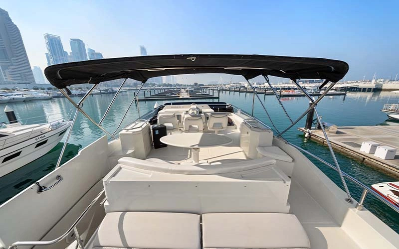 Guests relaxing on the bow of Lava Yacht during a sunset cruise near Palm Jumeirah
