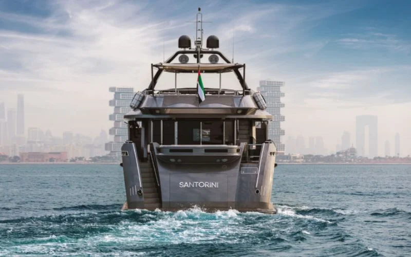 "Spacious upper deck of Santorini Silver yacht under sunny skies – Mala Yachts yacht rental in Dubai"