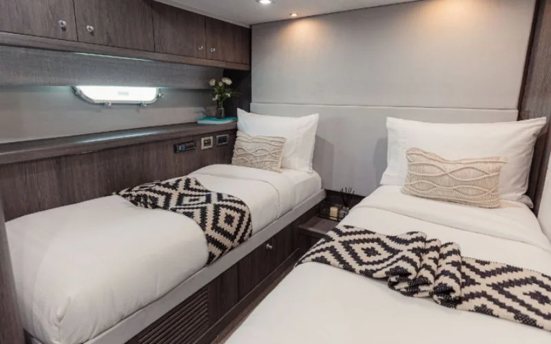Guest cabin with twin beds and elegant interior on Matrix Yacht