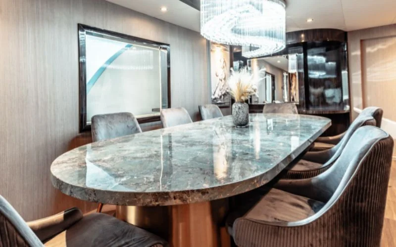 Foldable dining table with built-in bench seating in the salon of D3 33 Yacht