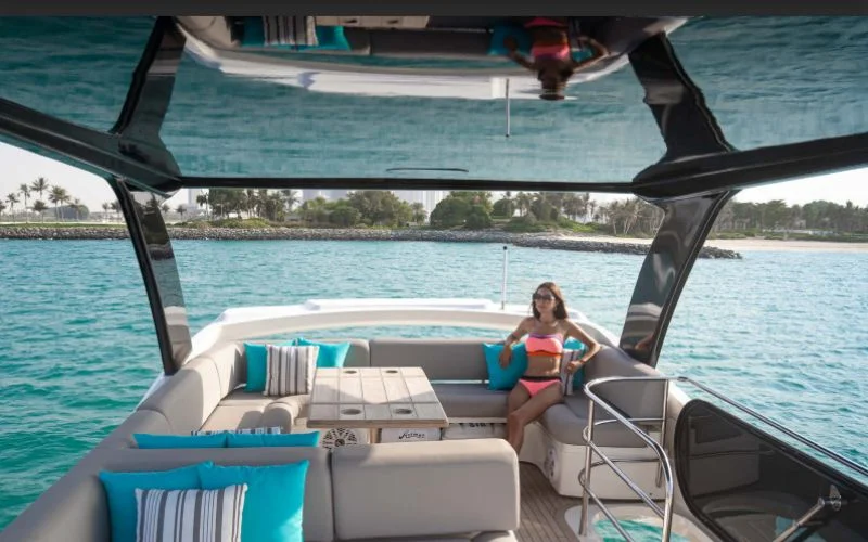"Modern lounge area inside Outlaw yacht with luxury seating – Mala Yachts premium yacht rental in Dubai"