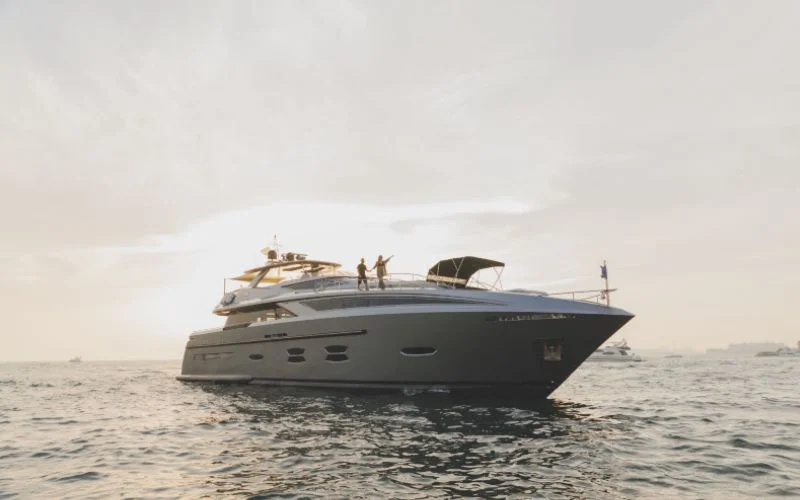 "Luxurious Santorini Silver yacht cruising with the Dubai skyline in the background – Mala Yachts yacht rental Dubai"