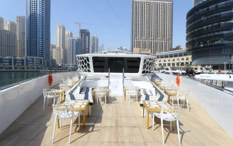 Intimate dining area near large windows offering ocean views aboard Lotus Royale Yacht