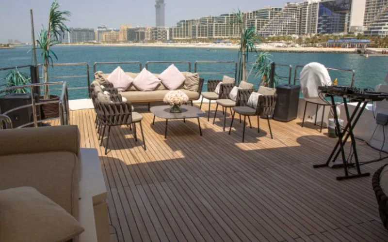 Dining area with wooden table and leather chairs in Khalili Yacht
