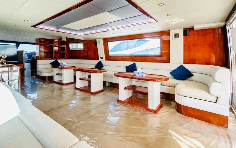 Lounge area with entertainment system and ambient lighting aboard Mayas Yacht