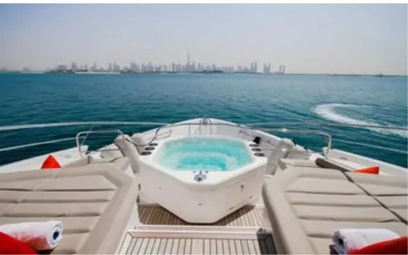Jacuzzi room with timber walls and tranquil lighting inside the yacht