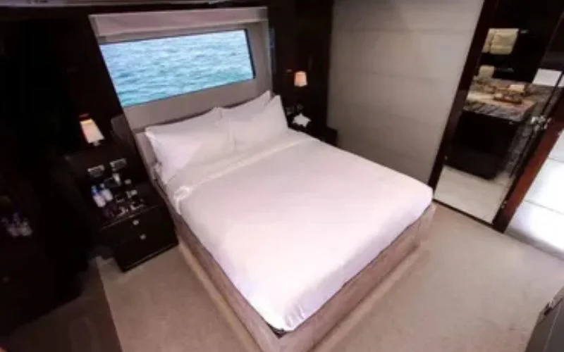 Private bedroom suite with modern styling and ambient lighting aboard the Legende Yacht