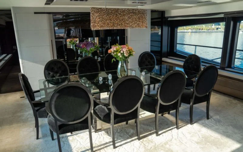 "Spacious dining area with modern décor inside Saffuriya yacht – Mala Yachts offering premium yacht rental in Dubai"