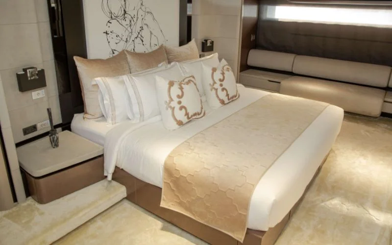 "Stylish bedroom with modern amenities aboard Saffuriya yacht – Mala Yachts luxury yacht rental in Dubai"