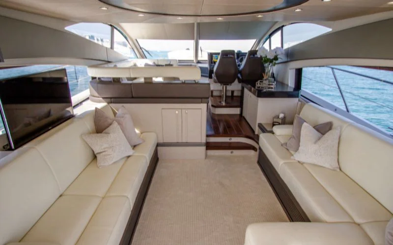 "Stylish interior lounge with ambient lighting in Outlaw yacht – Mala Yachts luxury yacht rental Dubai experience"