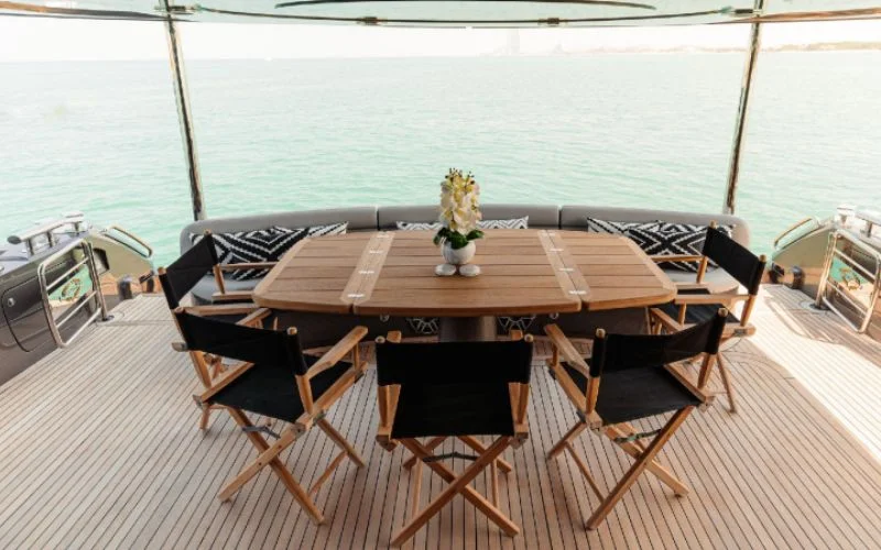 Dining chairs with leather finish around the table inside Matrix Yacht