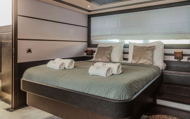 Modern bedroom with soft lighting and ocean views on Morrigan Yacht