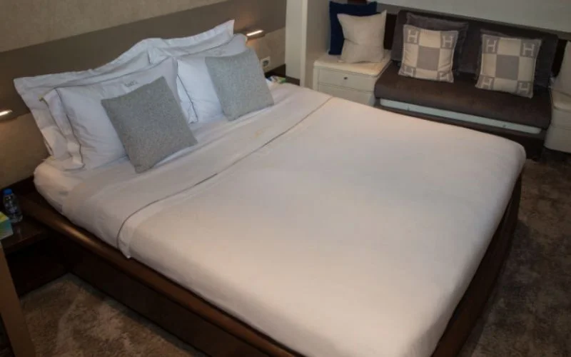 Master bedroom with premium bedding and wide sea-facing windows aboard Khalili Yacht