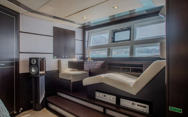 Reading nook with bookshelf and seating in Morrigan Yacht interior