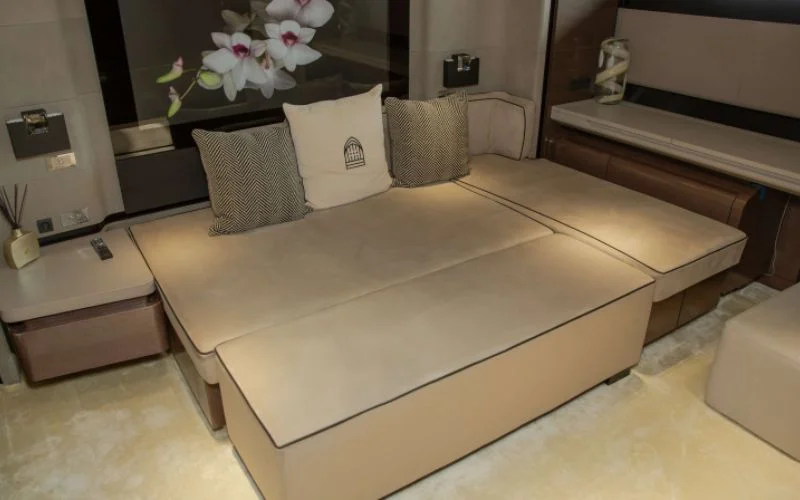 "Elegant bedroom suite aboard Saffuriya yacht featuring soft lighting and premium bedding – Mala Yachts luxury yacht rental in Dubai"