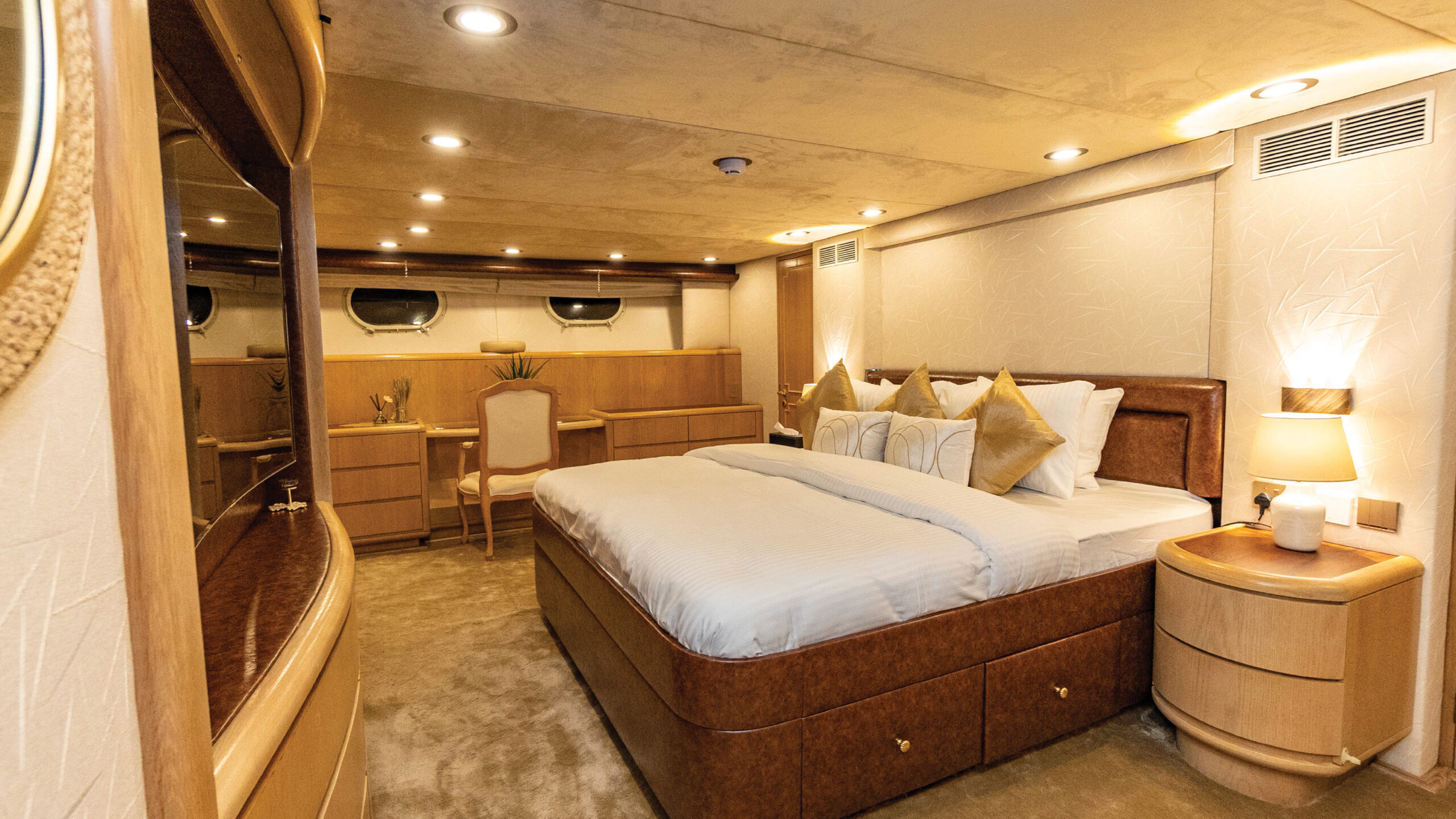 "Elegant bedroom suite inside Poseidon yacht with cozy furnishings – Mala Yachts luxury yacht rental in Dubai"