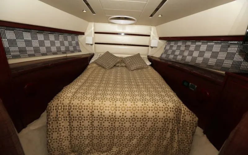 Master bedroom with soft lighting and full-length windows aboard Al Shali Yacht