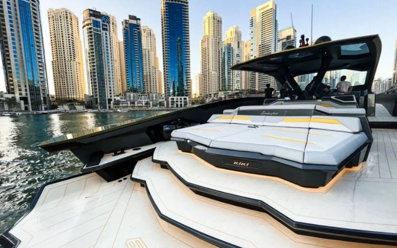 Lamborghini‑inspired carbon‑fiber helm with digital display and dual start‑stop buttons aboard Tecnomar 63 yacht