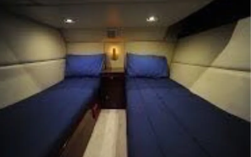 Guest cabin with twin beds and cozy interior décor in Al Shali Yacht