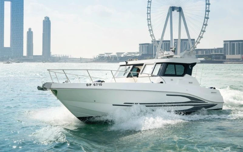 Compact and modern Storm 36ft yacht sailing along Dubai’s coastline – enjoy personalized yacht rental in Dubai with Mala Yachts.