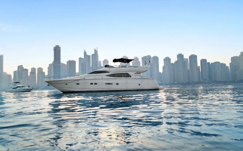 Gulf Craft 60ft yacht cruising along Dubai’s coastline with a sleek white finish – elevate your sea adventure with Mala Yachts’ yacht rental in Dubai.