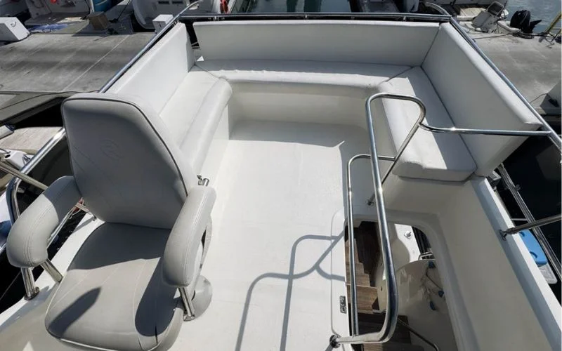 Lounge and dining combo space aboard the Riviera yacht with elegant interiors – perfect for socializing on your Mala Yachts yacht rental in Dubai.