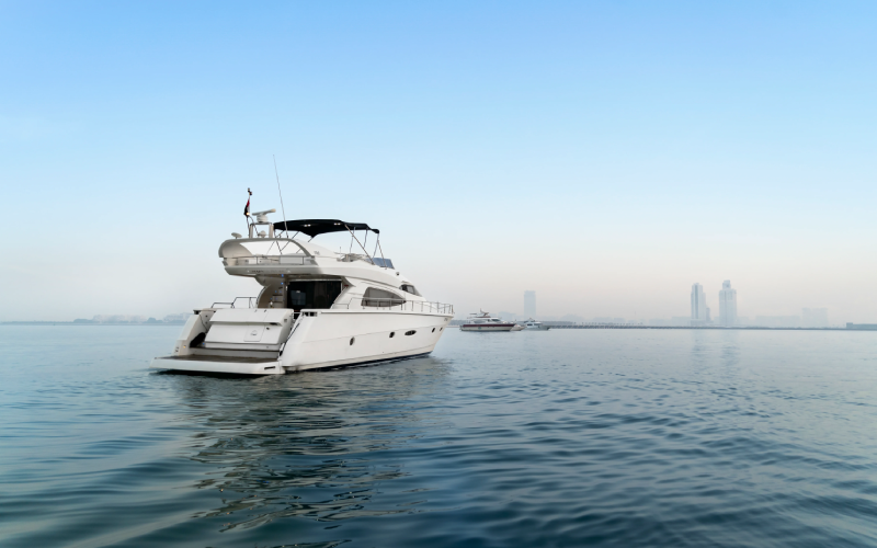 Top-deck view of Gulf Craft 60ft yacht with sun loungers and ocean backdrop – unwind in style with Mala Yachts’ premium yacht rental in Dubai.