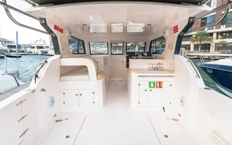 Spacious lounge area inside the Thunder yacht with elegant furnishings and ambient lighting – Mala Yachts provides top-tier yacht rental in Dubai for relaxing onboard moments.