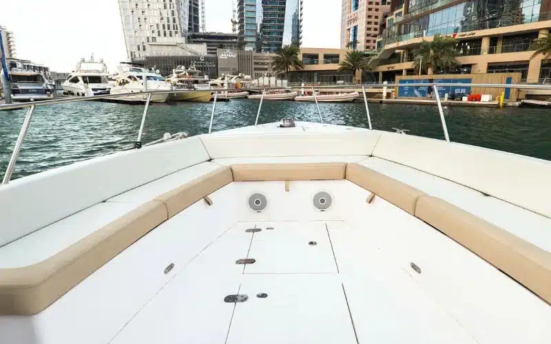 Clean and modern interior of the Thunder yacht with comfortable seating and wooden accents – Mala Yachts offers elegant and affordable yacht rental in Dubai.