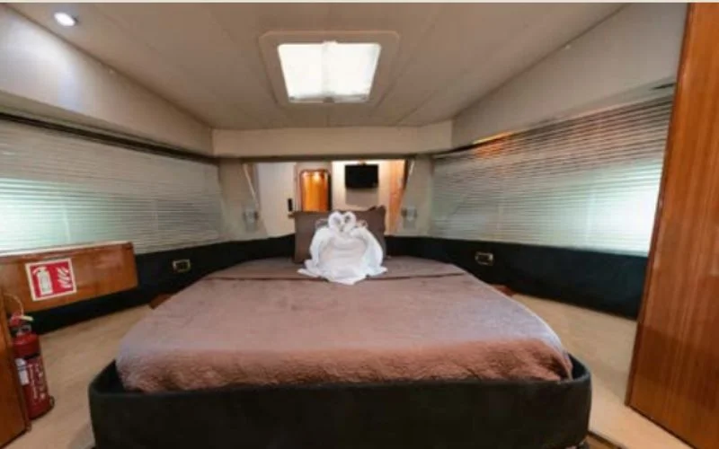 Luxurious bedroom onboard the Etosha yacht with elegant décor and ambient lighting – Mala Yachts offers premium yacht rental in Dubai for overnight stays in style.