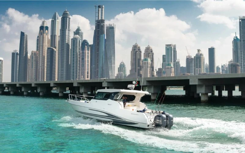 Storm 36ft yacht cruising with vibrant Dubai skyline in the background – Mala Yachts delivers unforgettable yacht rental in Dubai experiences.