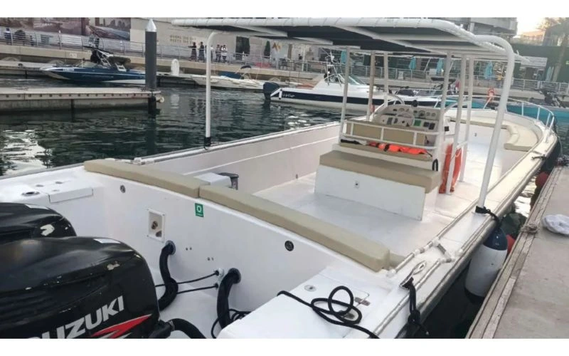 View of a well-equipped boat from the Mala Yachts fleet, with twin outboard motors, awaiting guests for a day of cruising or fishing with the best yacht rental in Dubai.