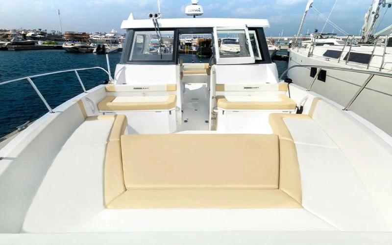 Cozy interior of the Storm 36ft yacht with sleek seating and modern finishes – Mala Yachts offers intimate yacht rental in Dubai for small gatherings.