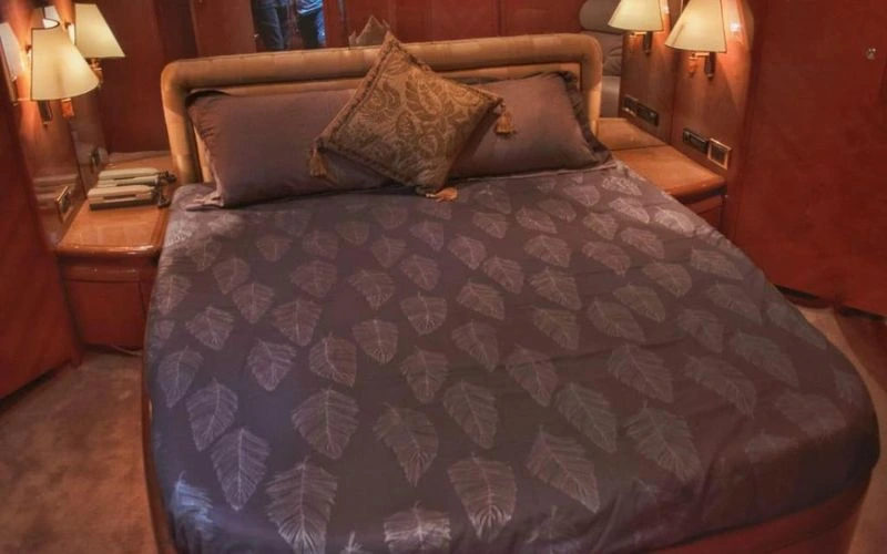 Luxurious bedroom suite with elegant lighting on a Mala Yachts vessel – ultimate comfort with premium yacht rental Dubai services.