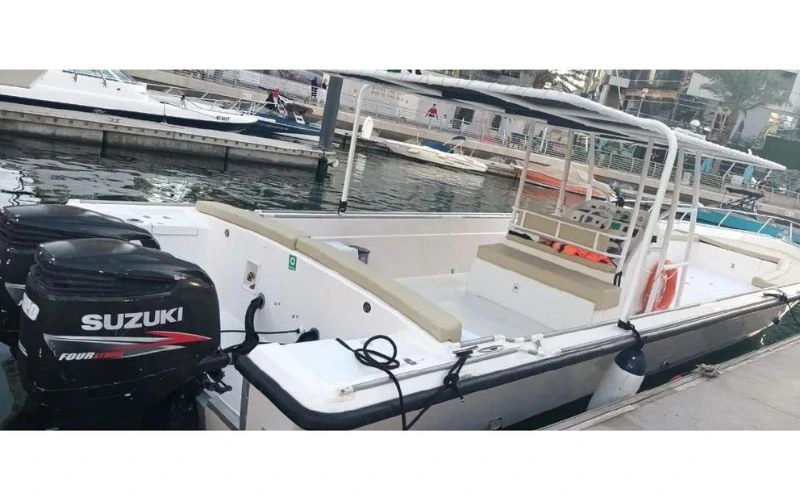 A clean and modern Mala Yachts boat docked at the pier, an ideal choice for a small group yacht rental in Dubai.
